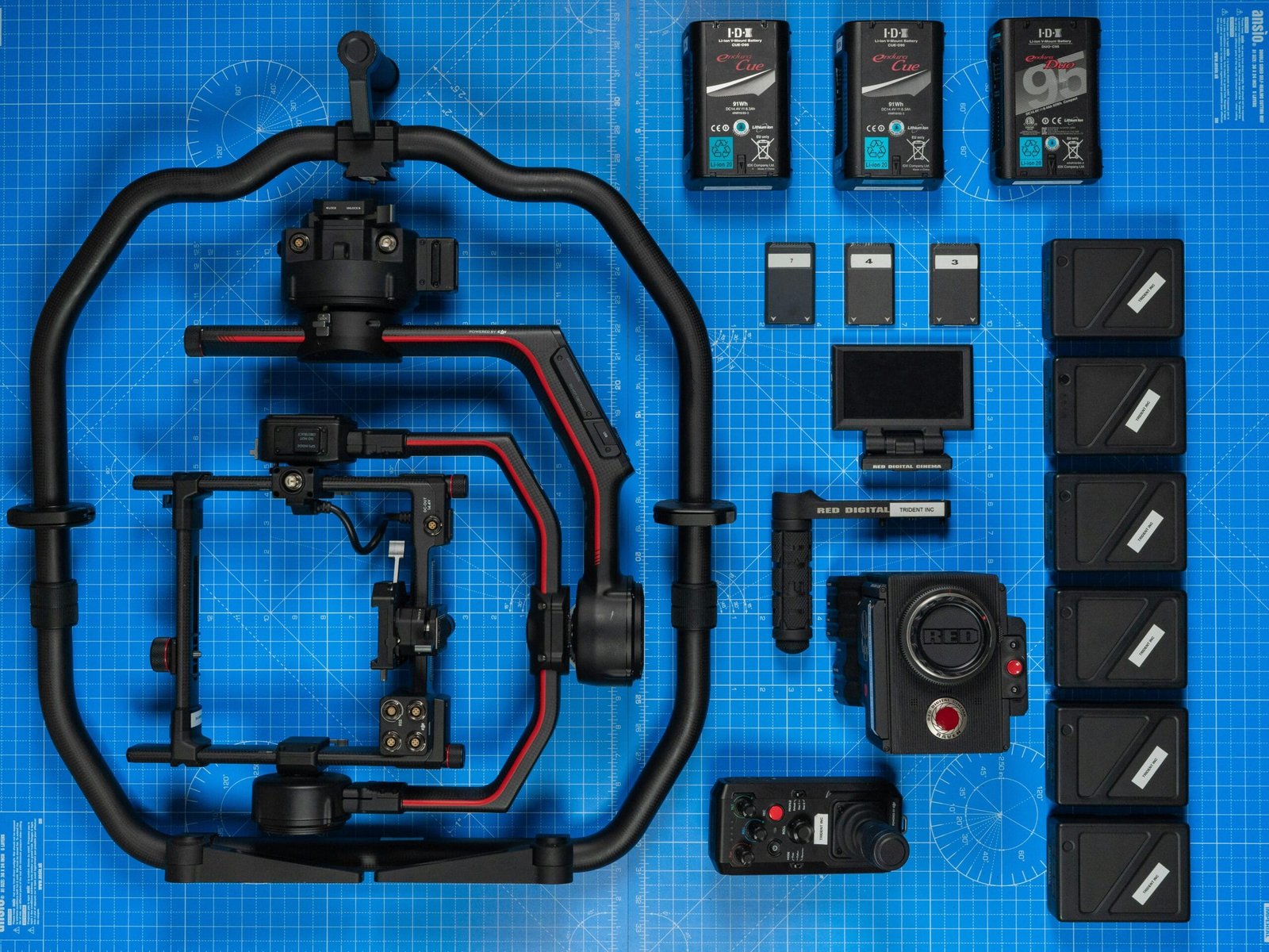 pexels-photo-13826435-13826435 Flat lay of high-end filmmaking camera gear and accessories on a blueprint background.